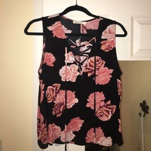 Floral tank top with lace up detail.